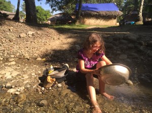 Evie helping with the dishes